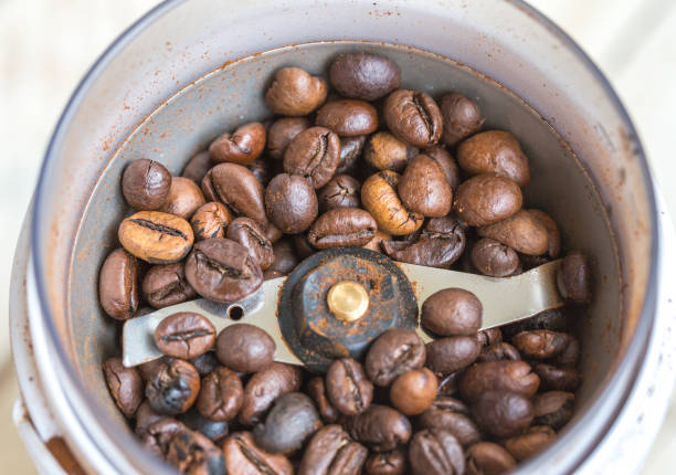 istock Fried coffee beans in a coffee grinder. Macro 1061221344