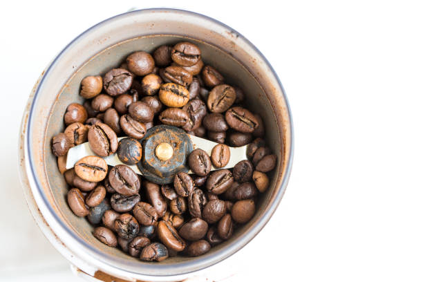 istock Fried coffee beans in a coffee grinder. Macro Vintage toning 1061221434