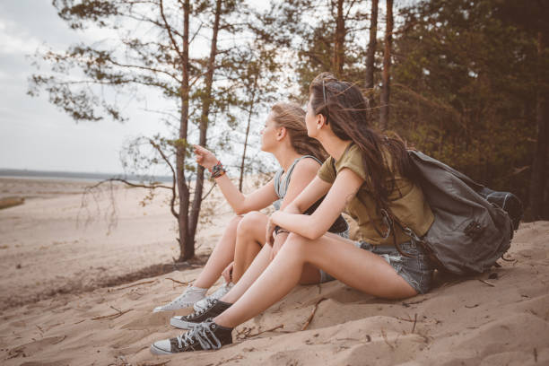 istock Two female friends sitting on the desert 1061226726