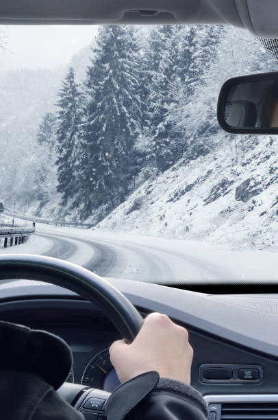 istock Winter Driving - Snow on a mountain road 1061227630