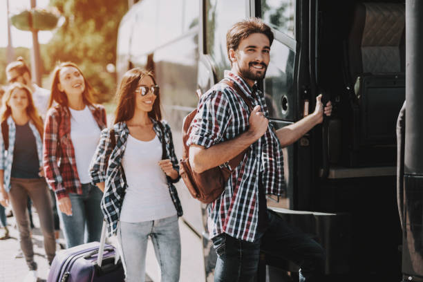 Group of Young People Boarding on Travel Bus stock photo