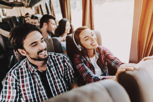 young smiling couple traveling on tourist bus - passeio público imagens e fotografias de stock