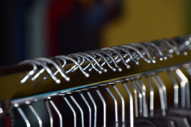 metal clothes hangers on clothes rail macro shot
