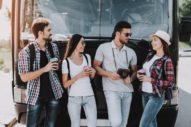 istock Young People Drinking Coffe in front of Tour Bus 1061230586
