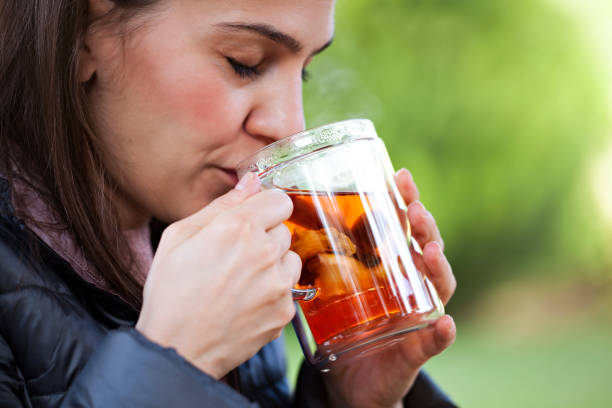 istock Young woman with herbal tea cup 1061233102
