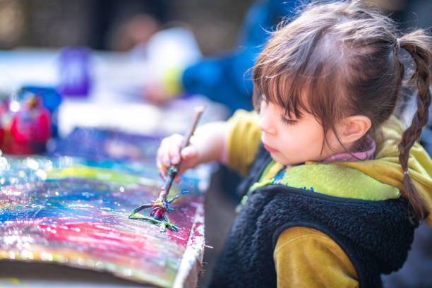 istock Cute girl painting 1061236616