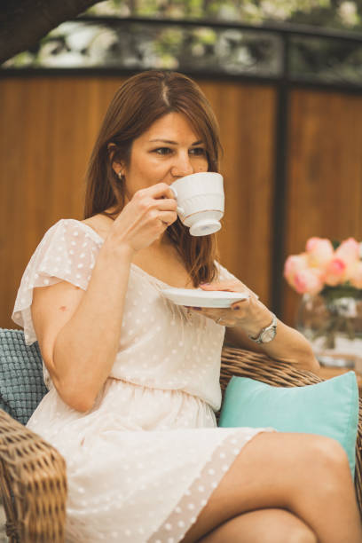 istock Woman drinking tea in the garden 1061236826