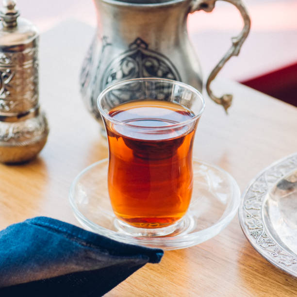 istock Turkish tea in authentic glass cup with delights. Closu up. 1061240204