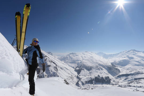 istock Woman climbs with skis above mountains 1061244962