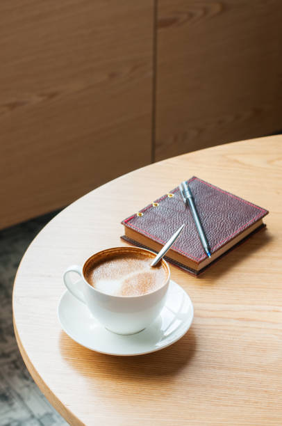 istock Cup of coffee and notebook with pen on a working table. Copy spa 1061248262