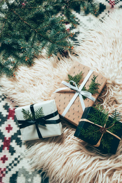 istock flat lay with pine tree branches and wrapped christmas presents on woolen backdrop 1061249418