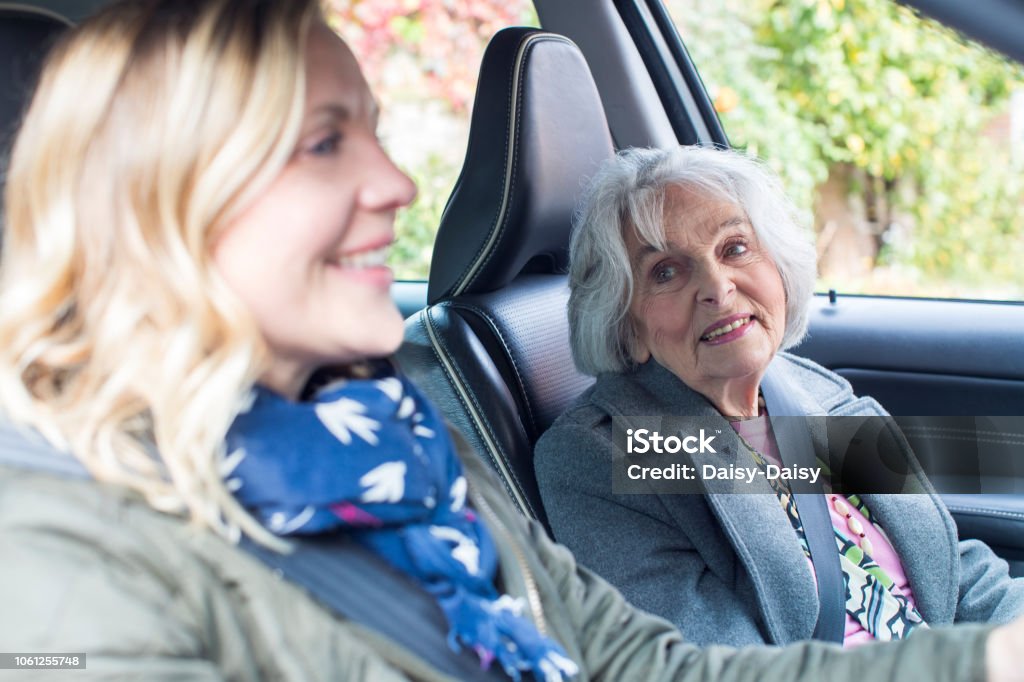 Female Neighbor Giving Senior Woman A Lift In Car Senior Adult Stock Photo