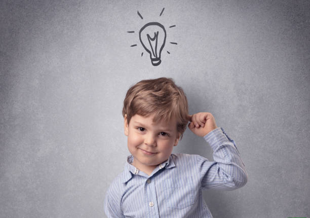 istock Smart kid in front of a drawn up grey wall 1061255844
