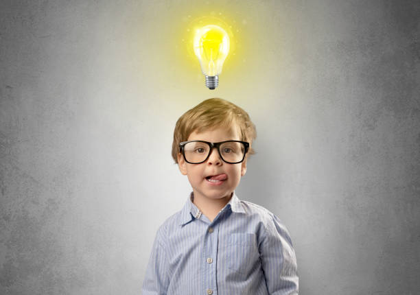 istock Little boy mull over with bulb above his head 1061256860