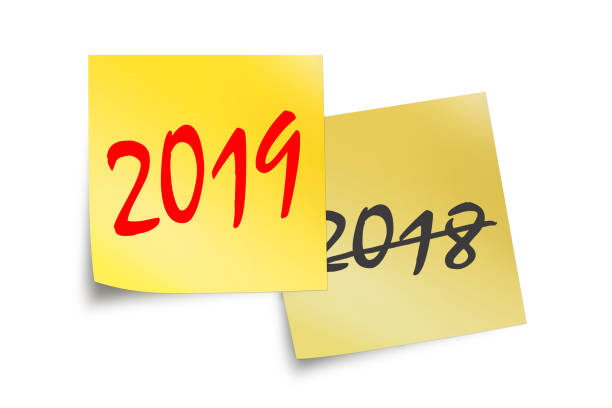 istock 2019 and 2018 written on yellow sticky notes isolated on white 1061258210