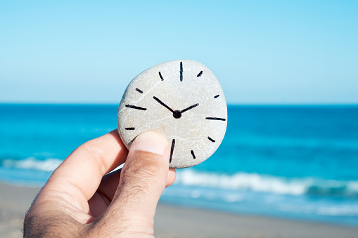 man and a stone with a clock drawn in it