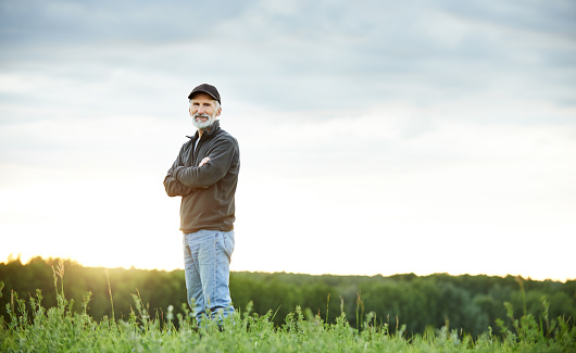 Portrait of a mature farmer standing on a field