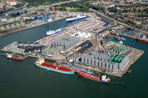 Aerial view of a oil and container terminal with moored ships in the Port of Rotterdam.