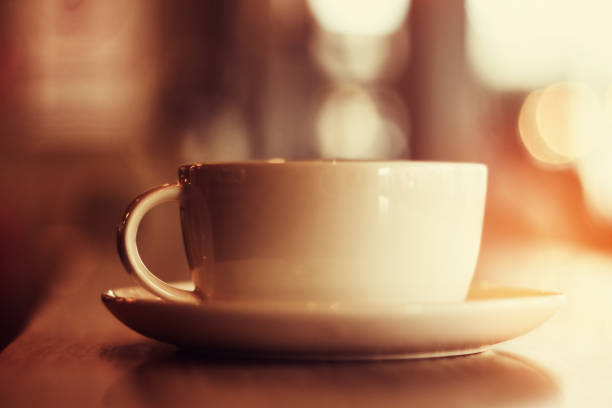 Sepia toned image of a coffee cup with nice bokeh at the background
