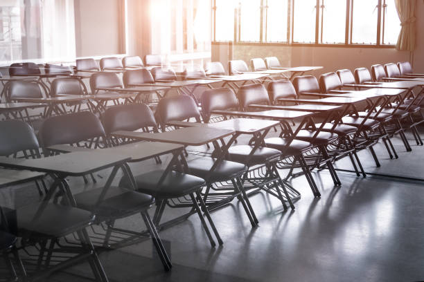 istock School empty classroom or Lecture room with desks chairs iron wood for studying lessons seminar in university of thailand, interior of class with whiteboard no kid  teacher, educational concept 1061283206
