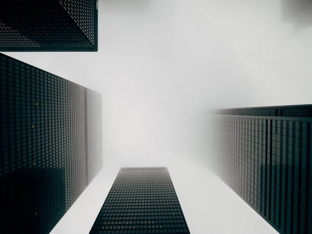 Aerial view of a downtown central business district with fog and mist amongst buildings in the morning sun