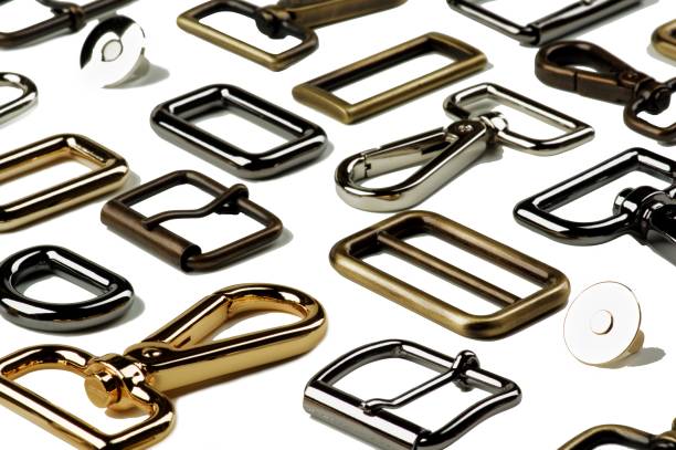Arrangement of Various Leather Haberdashery with Gold, Silver and Bronze Buckles, Ellipses and Fasteners closeup on White background