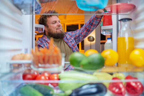 istock Man looking something to eat at night. 1061284866