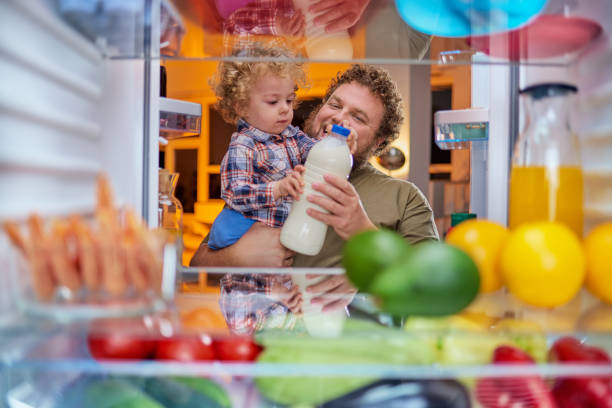 istock Father and son taking milk from fridge in late hours. 1061285354