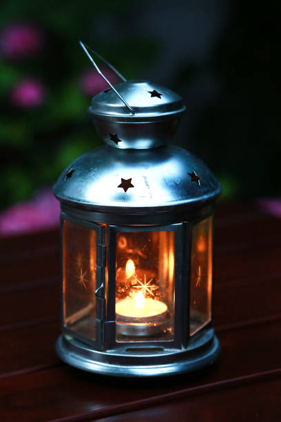 istock Vintage styled lamp with a candle at night as a background 1061285598