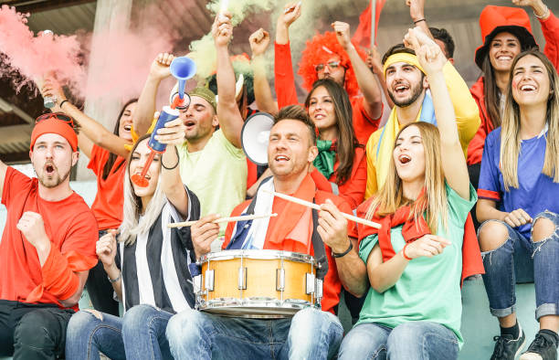 football supporter fans watching international soccer match - young group of excited friends having fun exulting at world game at stadium - youth, sport and celebration score concept - soccer celebration success group of people imagens e fotografias de stock