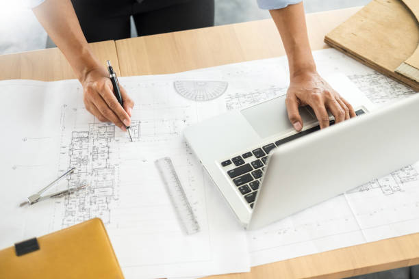 istock Cropped Image Of Architect Drawing Blueprint At Desk 1061289044