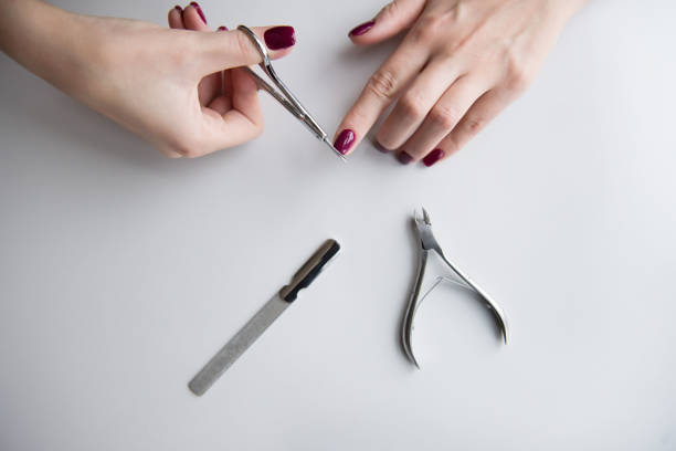 istock Manicured hands on white background. Red manicure. 1061291312