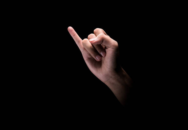 Male hand making pinky swear sign Male hand making pinky swear sign over dark background pinky finger stock pictures, royalty-free photos & images