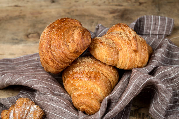 istock freshly baked buns with almonds. Croissants and brioches 1061296244