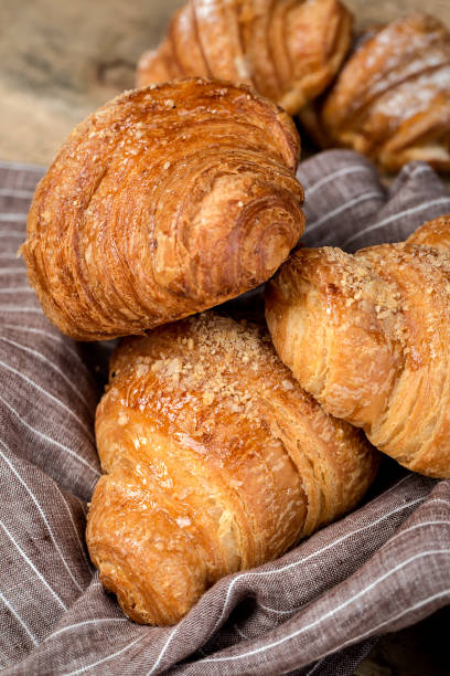 istock freshly baked buns with almonds. Croissants and brioches 1061296270