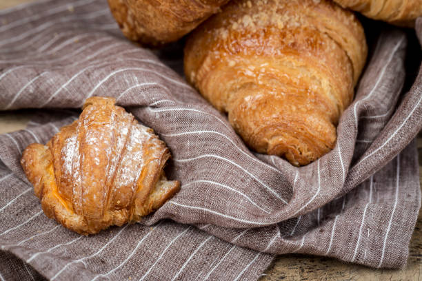 istock freshly baked buns with almonds. Croissants and brioches 1061296278
