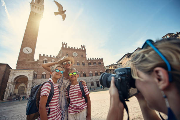 Family sightseeing Siena, Italy Mother and three little tourists sightseeing Siena. The kids are standing in Piazza del Campo posing for photos. Mother is taking photos of her kids. Torre del Mangia and Palazzo Pubblico visible in the background. Sunny Summer day.
Nikon D850 torre del mangia stock pictures, royalty-free photos & images