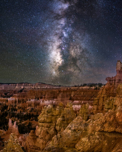 bryce canyon national park at night with milky way. Utah. USA Nightshot in bryce canyon national park with milkyway in the background and the hoodoos in the foreground. Utah. USA sunrise point stock pictures, royalty-free photos & images