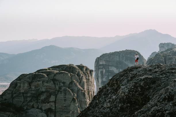 istock Man Standing On Mountains Against Sky 1061300230
