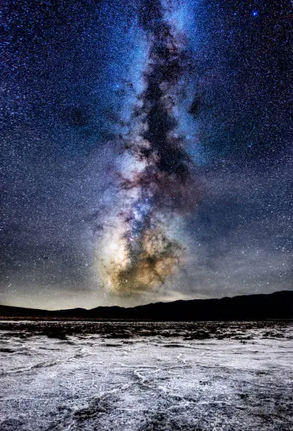 Salt flats macro at night in Badwater basin, death valley national park with milky way in the background. California. USA