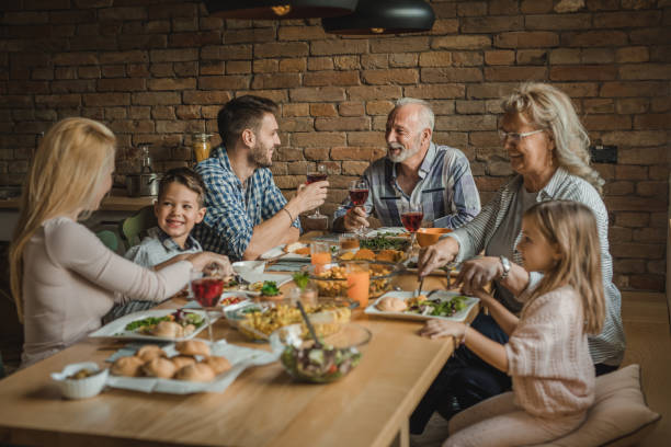 istock Happy multi-generation family enjoying in conversation during lunch at dining table. 1061305734