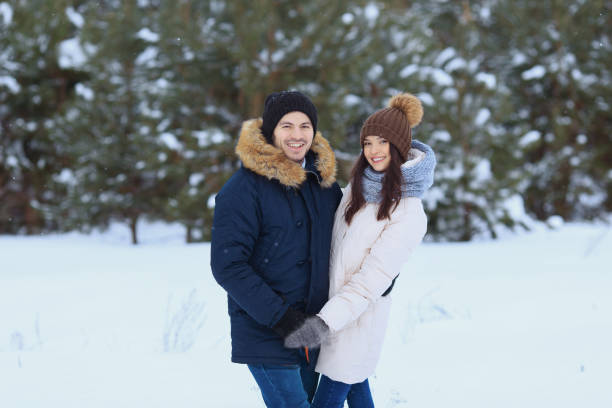 istock Love couple walking in winter forest 1061306488