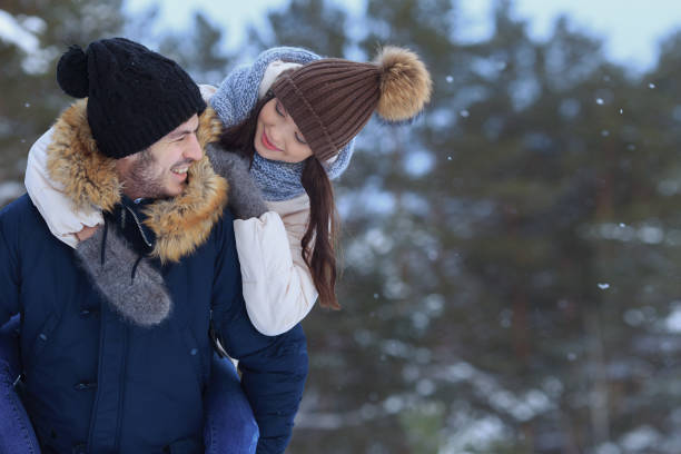 istock Playful smiling couple walking in winter forest. copy space 1061306502