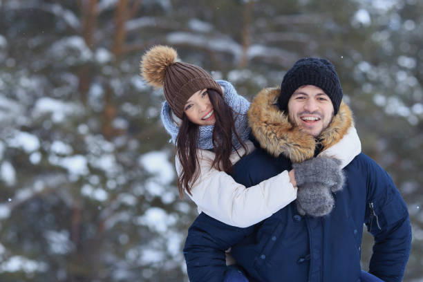 istock Playful young couple walking in winter forest 1061306662