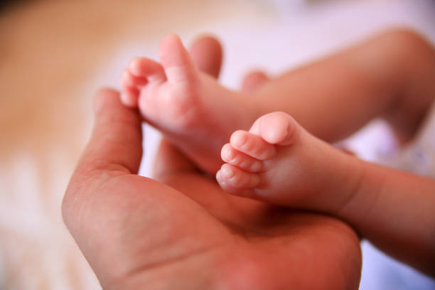 istock Father holding baby feet 1061306720