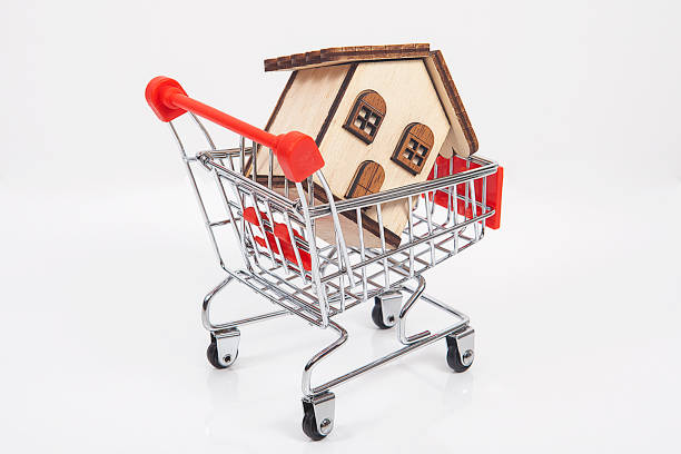 istock Gift package and small toy shopping cart on table. 1061307936