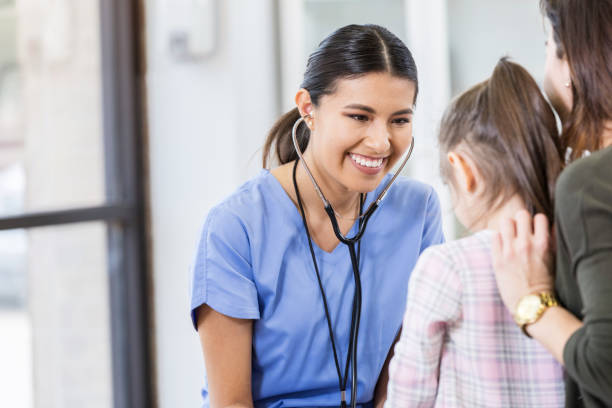 istock Cheerful pediatrician listens to young patient 1061308064