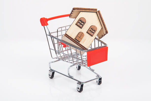istock Gift package and small toy shopping cart on table. 1061308108