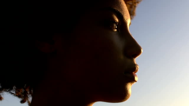 Close-up face of beautiful sad woman enjoying sunset, purity and sincerity