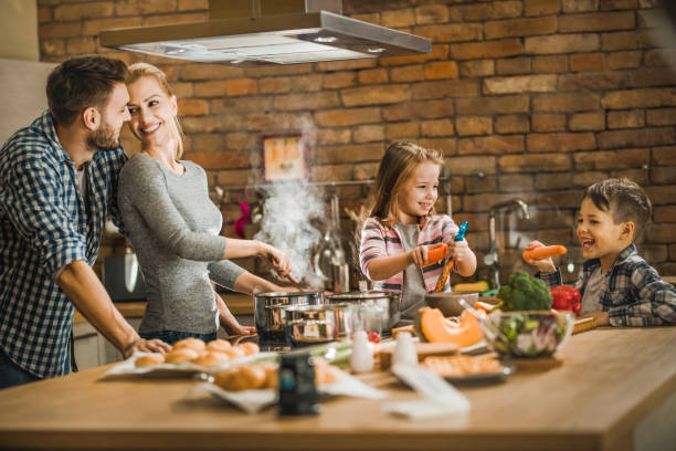 istock Happy family enjoying while making lunch in the kitchen. 1061309042